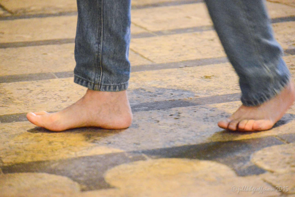 Man walking the labyrinth in bare feet at the Chartres Cathedral by photographer Jill K H Geoffrion