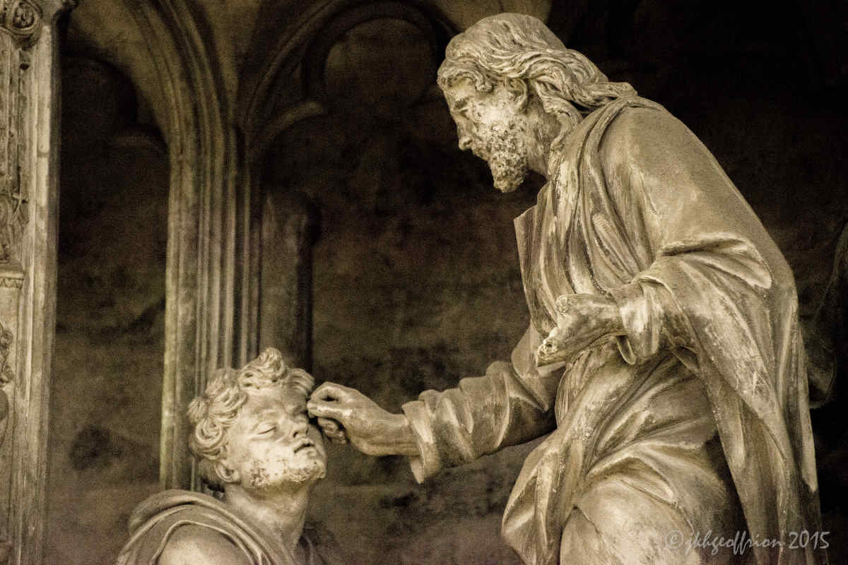 Jesus opening the eyes of the blind man, outer choir sculpture at Chartres Cathedral by photographer Jill K H Geoffrion