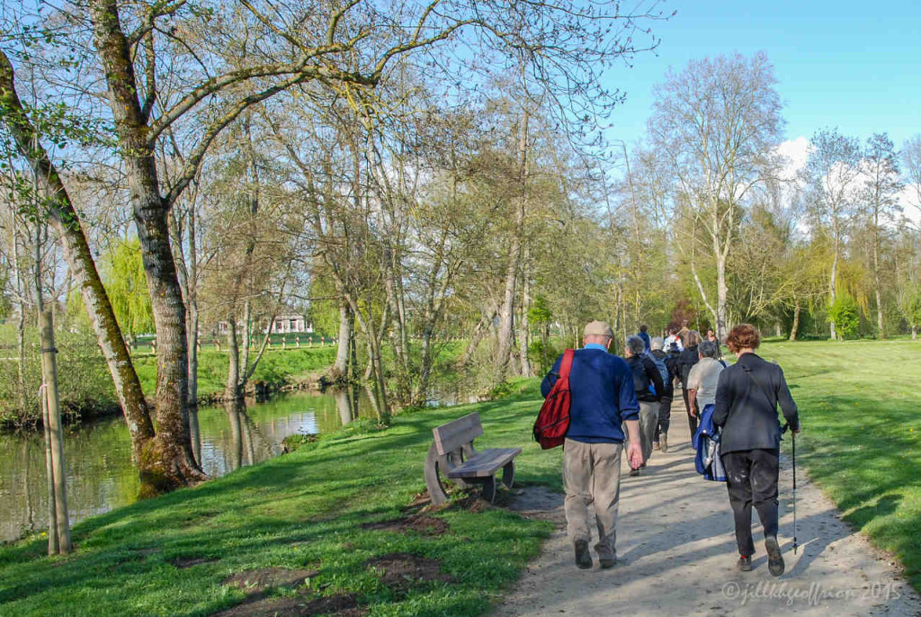 Pilgrims walking along the Eure River towards the cathedral in Chartres by Jill Geoffrion, photographer