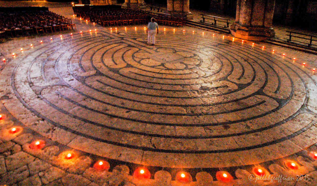 Labyrinth walker at night with candles