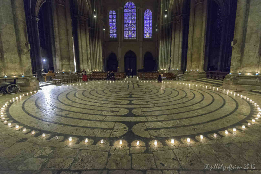 Lighting candles around the outside of the labyrinth by Jill K H Geoffrion